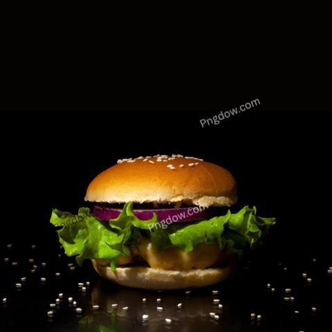 Fast food concept Burger with cutlet, cheese, onions and lettuce on a black background